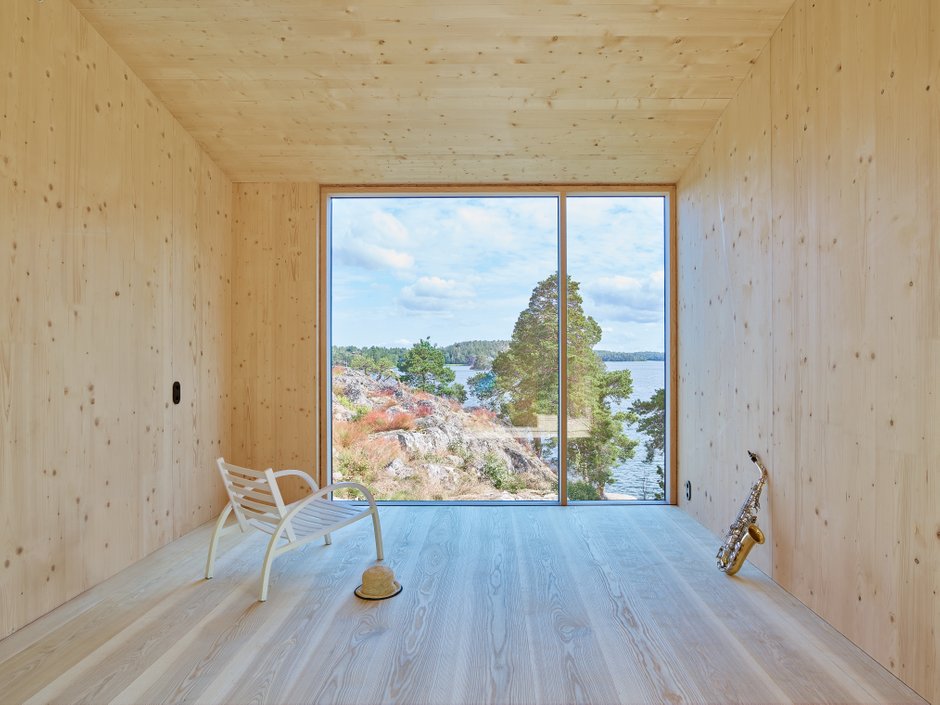 Interior view of CLT house  under construction with a framed view on the archipelago through a large window